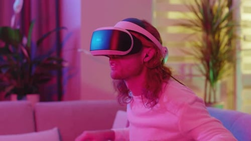 Young Adult Playing Virtual Reality Game at Home