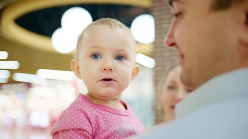 Cute Baby and Parent in Shopping Center
