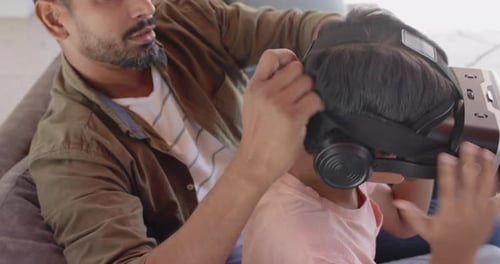 Dad Helps Child Use Virtual Reality Headset