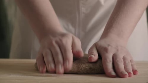 Woman Hands Close Up Kneading Dough on Floured Table Preparing Home Made Sourdough Wheat Bread