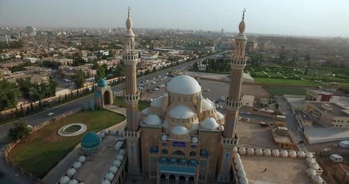 Drone shot between the mosque's two minarets and many domes