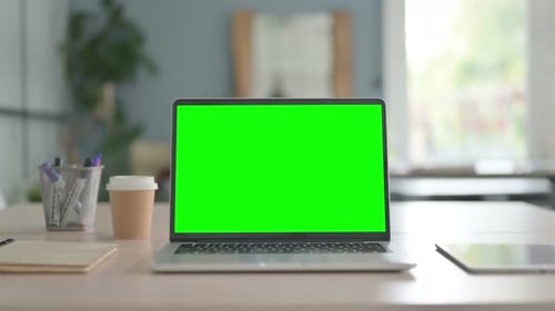 Laptop with Green Screen on Desk in Office, Chroma Key