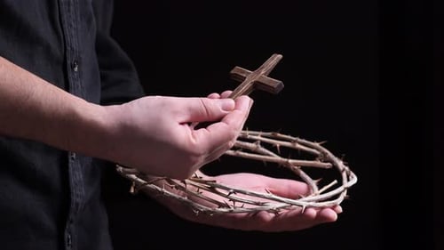 Priest Holding Crown of Thorns and Small Wooden Cross in Hands