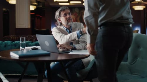 Male Colleagues Working in Office Cafe