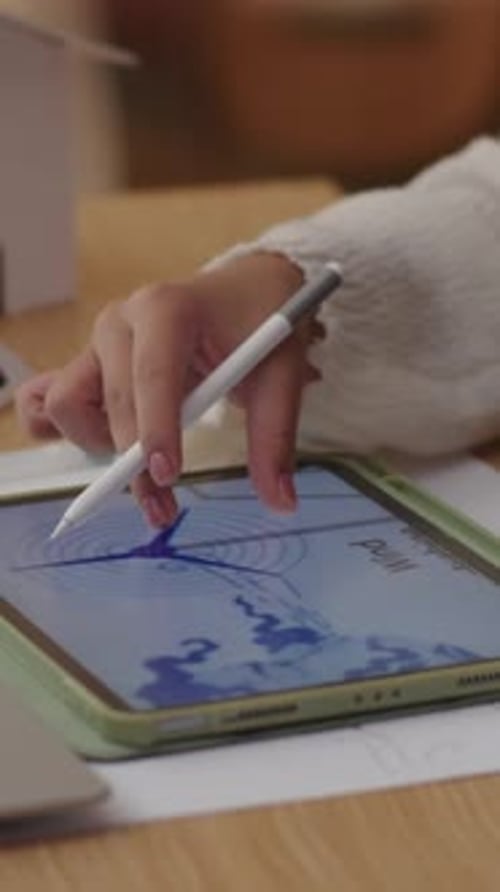 Hands of Student Examining Scheme on Tablet PC