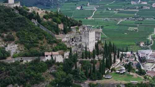 Camera panning over medieval castle ruins and italian countryside
