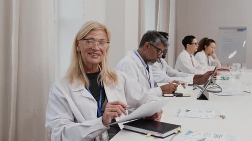 Doctors in Meeting Reviewing Data and Discussing Treatment