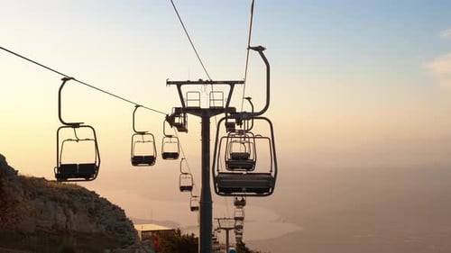 Empty Chairlifts Ascending the Mountain at Sunset