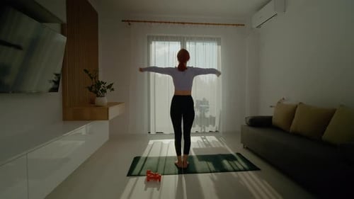 Woman Stretching Arms on Yoga Mat Indoors