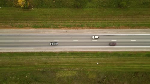 Cars Riding Through Countryside Road at Autumn Season Auto Driving at Rural Route Near Yellow Fields