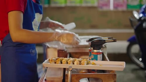 Unrecognizable Thai Female Working at Flea Market in Chiang Mai Preparing Sushi Tray Slow Motion