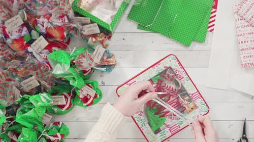 Hands Tying Christmas Ribbon on Homemade Fudge
