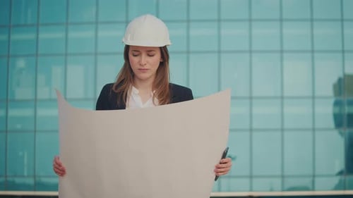Portrait of a Successful Female Engineer or Architect Wearing a White Helmet