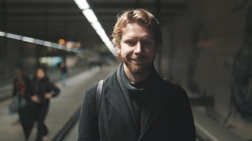 Handsome Man Commuting on an Airport Walkalator