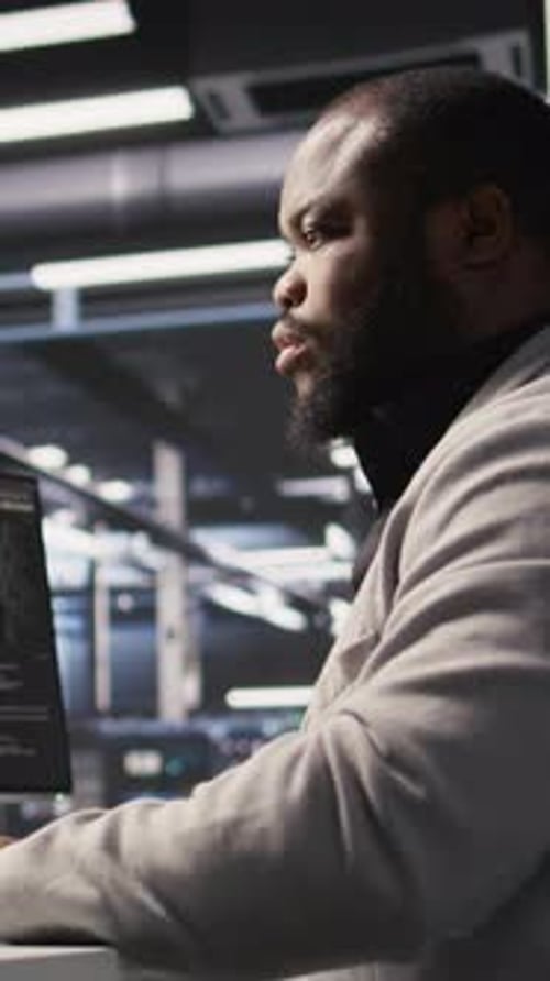 Vertical Video Data Center Computer Scientist Monitoring Servers Performing AI Training