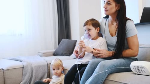 Mother and Children with Nebulizer at Home