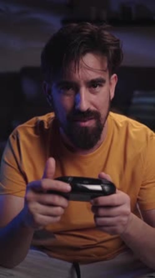 Young Man Playing a Video Game at Home