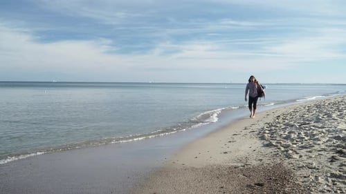 Man with Backpack Tramping by Seaside