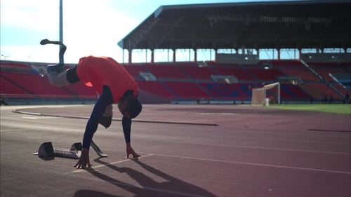 Disabled athletes prepare in starting position ready to run on stadium track