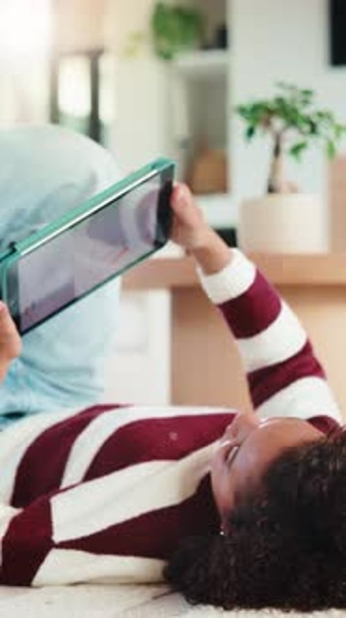Child, reading and elearning with tablet in home, growth or skill development with assignment
