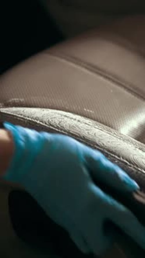 Worker in Gloves is Washing with Brush a Car Seats