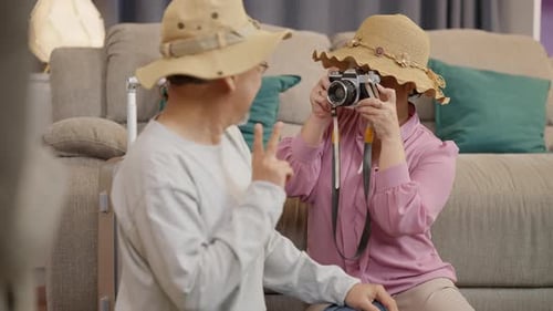 Woman Takes Picture of Man with Camera