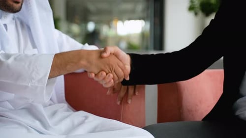 Business People Shaking Hands in Modern Office