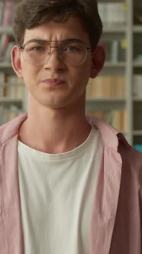 Upset Caucasian Student Guy Looking at Camera Showing Dislike Thumb Down School Library Book Shop
