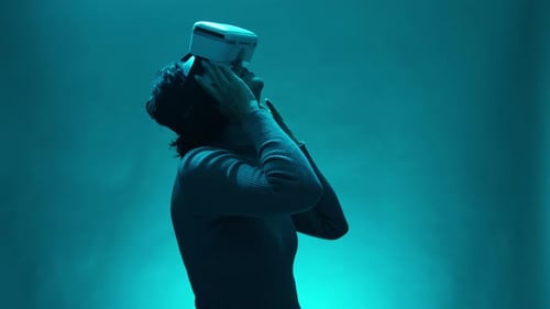 Woman Takes Off Virtual Reality Headset in Blue Light