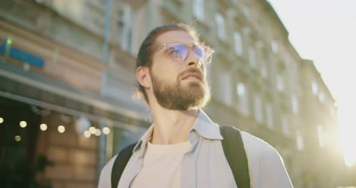 Close Up of Handsome Male Tourist in Sunglasses Exploring New City Travelling Admiringly Looking at
