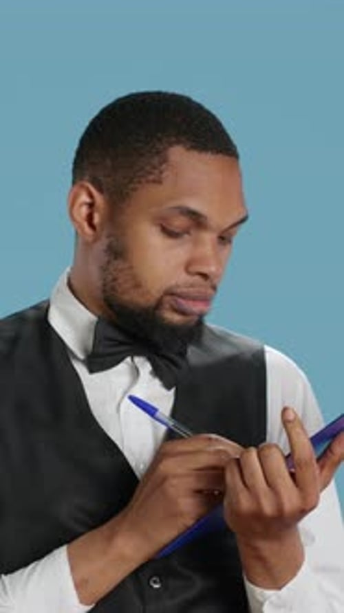 Vertical Video Receptionist Worker Writing Down Notes on Clipboard Files