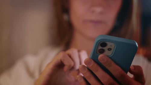 Woman Using Smart Phone in Home at Night