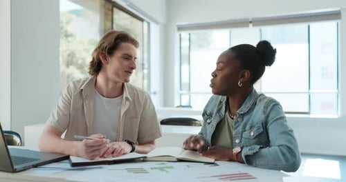 Young Adults Collaborating on a Project in Office