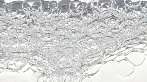 Macro Shot of Different Sized Clear Air Bubbles in Clear Water Rising Up on White Background Body