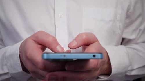 Male Hands Close Up Writing a Message on a Blue Smartphone Front View