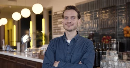 Portrait of proud small business owner in cafe restaurant looking to camera