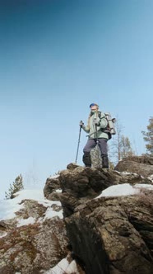 Hiker Standing on Top of Mountain Against Sky Vertical