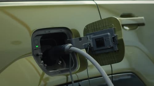 Closeup of EV Vehicle Connected to Charging Dock Emphasizing Sustainability