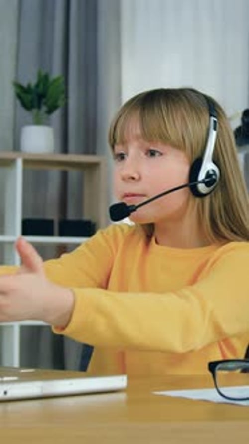 Distant School Education Concept Where Cute Excited Primary Schoolgirl Wearing Headphones Talking