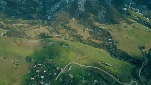 Scenic Aerial View of Village and Snow Mountains