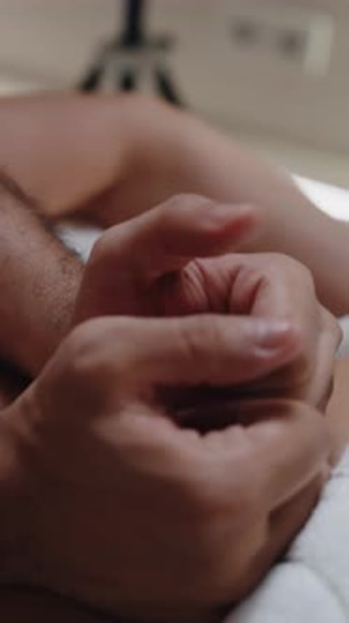 Hands Massaging Lower Back During Spa Session