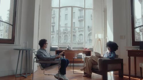 Man and Woman Talking in Sunny Apartment