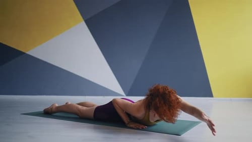 Young Adult Woman Practicing Yoga In Fitness Studio Athletic Lady Lying On Floor And Doing Exercise