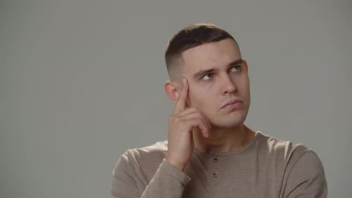 Pensive Man Thinking with Finger on Face