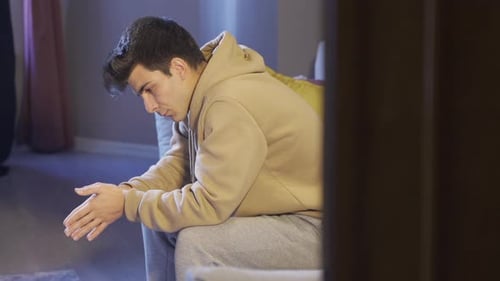 Depressed young man thoughtful and worried alone.