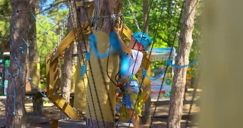 Child Navigating Ropes Course in Outdoor Adventure Park