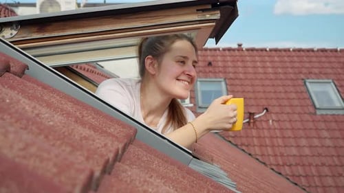 Woman Drinking From Mug Through a Window
