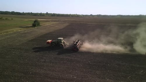 Tractor on the field seeding wheat