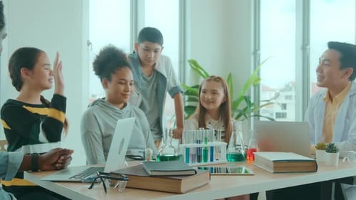 group of students studying and playing with teacher