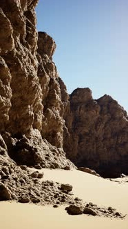 Sandy Beach Adjacent to Rocky Cliff